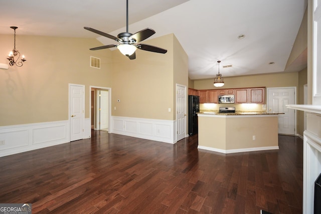 kitchen featuring visible vents, brown cabinets, pendant lighting, dark wood-style floors, and appliances with stainless steel finishes