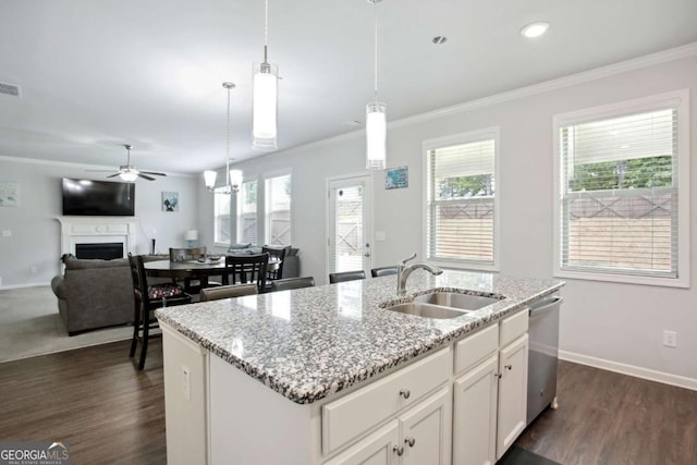 kitchen with dishwasher, sink, decorative light fixtures, a center island with sink, and white cabinets