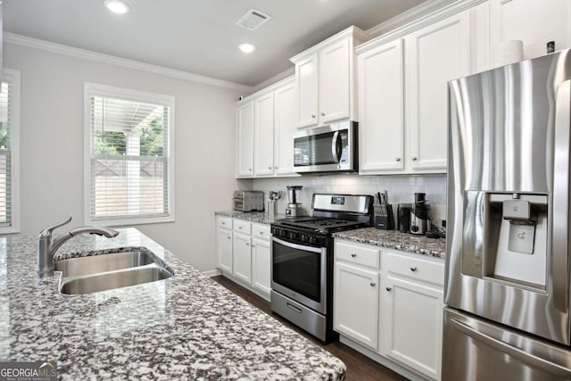 kitchen featuring white cabinets, light stone counters, sink, and stainless steel appliances