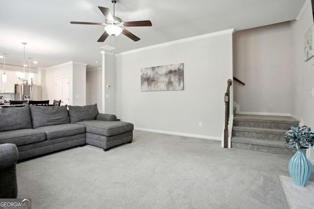 carpeted living room featuring ceiling fan and ornamental molding