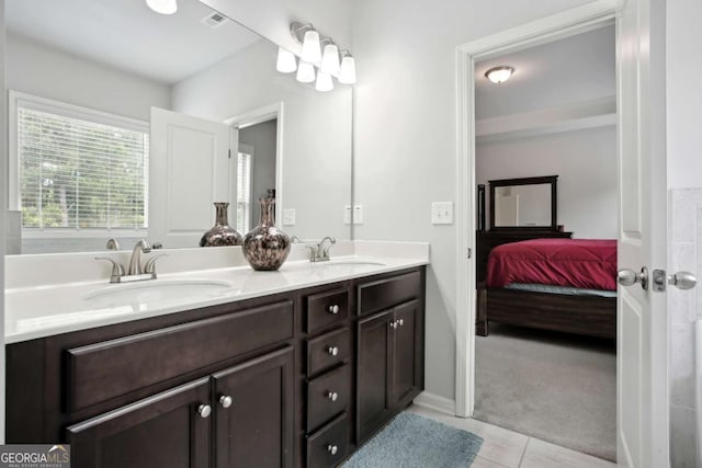 bathroom with tile patterned floors and vanity