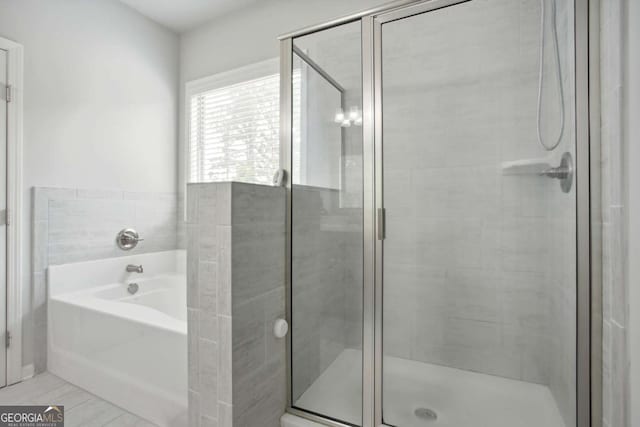 bathroom with shower with separate bathtub