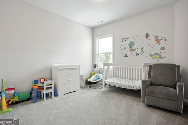 carpeted bedroom with a crib