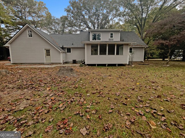 back of house with a lawn