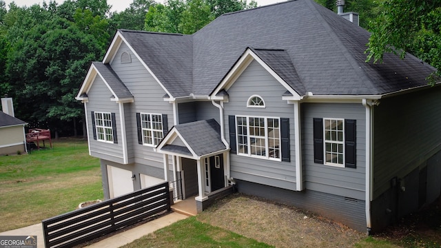 view of front of property with a front yard and a garage