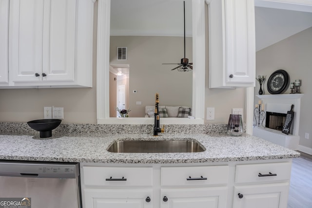 kitchen featuring sink, light hardwood / wood-style flooring, stainless steel dishwasher, ceiling fan, and white cabinetry