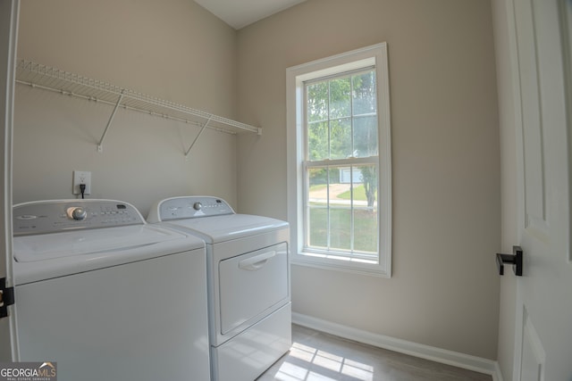 washroom featuring washer and dryer and light hardwood / wood-style flooring