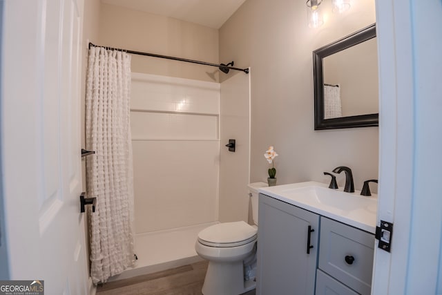 bathroom featuring vanity, curtained shower, toilet, and wood-type flooring