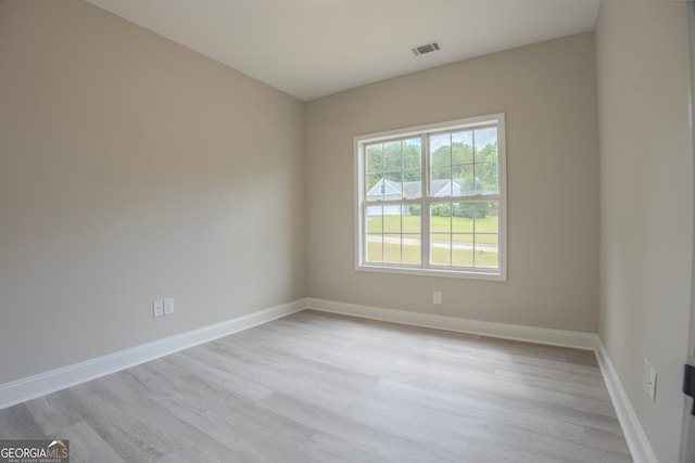 empty room with light hardwood / wood-style flooring