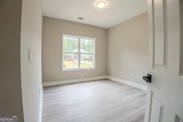 unfurnished room with light hardwood / wood-style floors