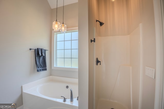 bathroom featuring separate shower and tub and a notable chandelier