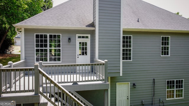 rear view of house with a wooden deck