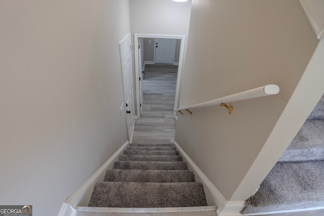 staircase featuring wood-type flooring