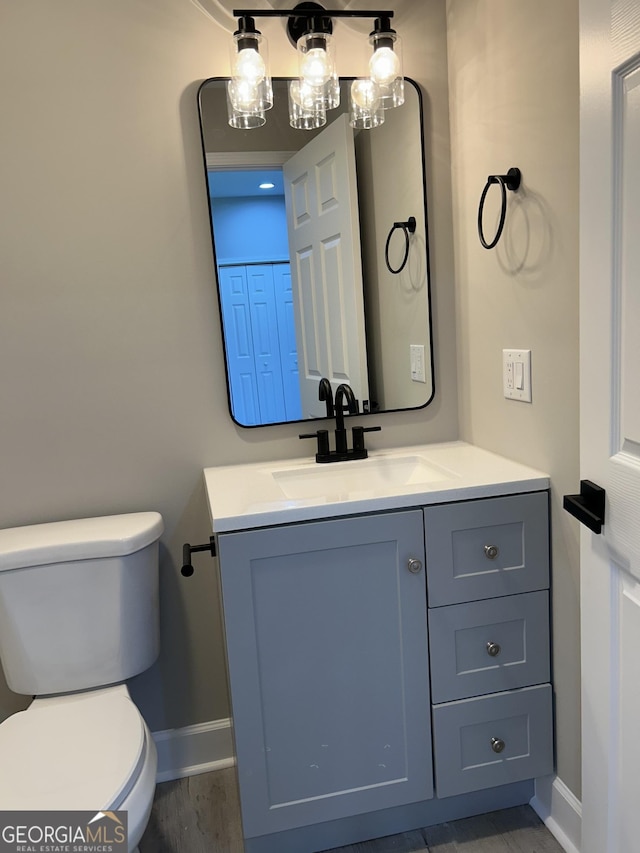 bathroom featuring vanity and toilet