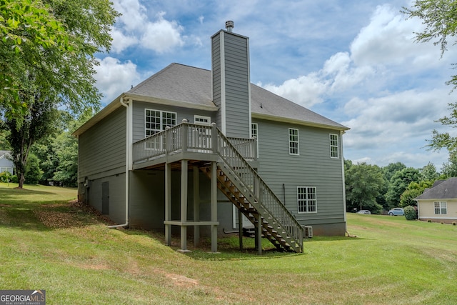 back of property featuring a lawn and a wooden deck