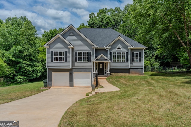 bi-level home with a front yard and a garage