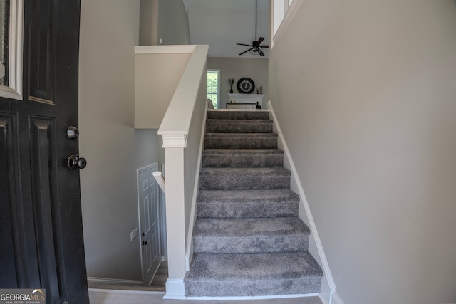 stairway with ceiling fan