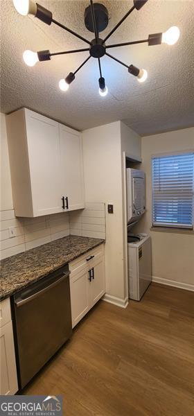 kitchen with white cabinets, dishwasher, backsplash, and dark wood-type flooring