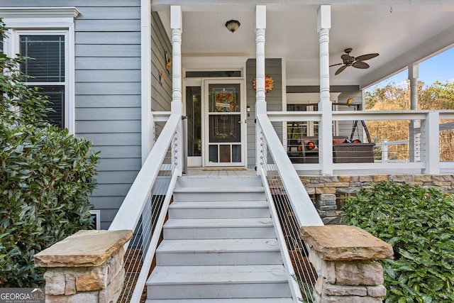 view of exterior entry featuring ceiling fan