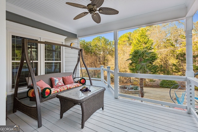 sunroom featuring ceiling fan