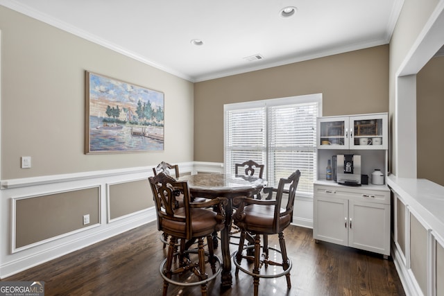 dining room featuring dark hardwood / wood-style flooring and ornamental molding