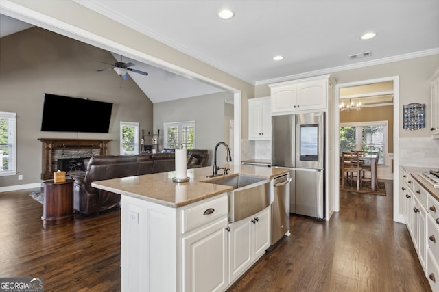 kitchen featuring sink, white cabinetry, appliances with stainless steel finishes, dark hardwood / wood-style floors, and an island with sink