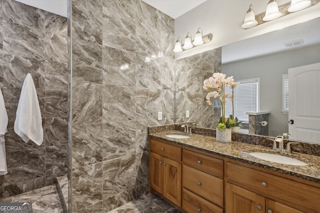 bathroom featuring vanity and tile walls