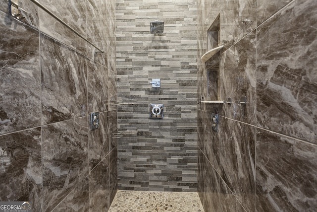 bathroom with a tile shower