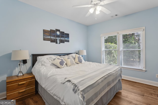 bedroom with wood-type flooring and ceiling fan