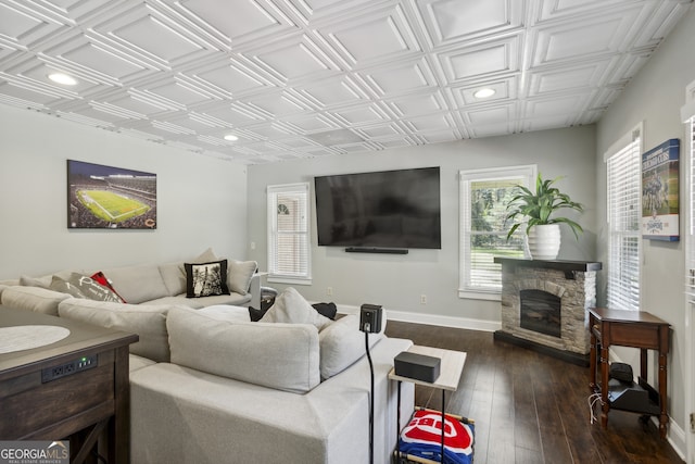 living room with dark wood-type flooring and a fireplace