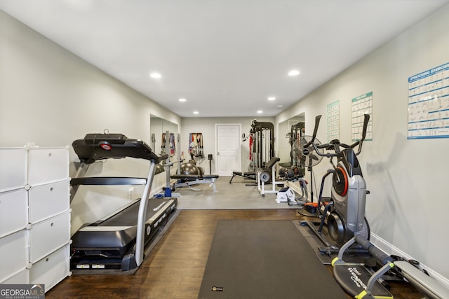 exercise room with dark hardwood / wood-style flooring