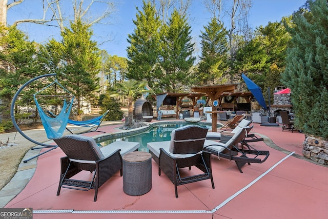 view of pool featuring a patio area and an outdoor stone fireplace