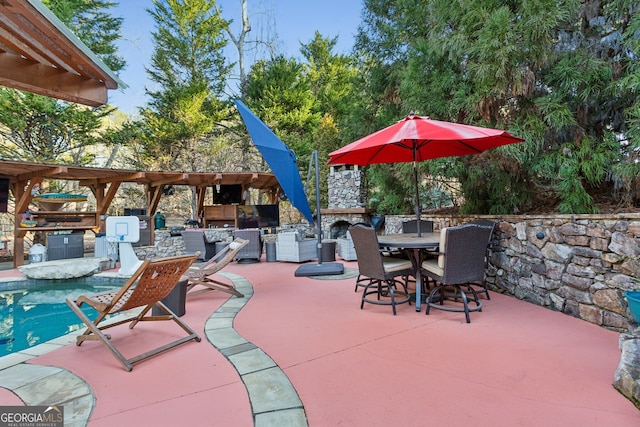 view of patio with a bar, exterior kitchen, and an outdoor stone fireplace