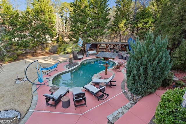 view of pool with a patio area and a fire pit