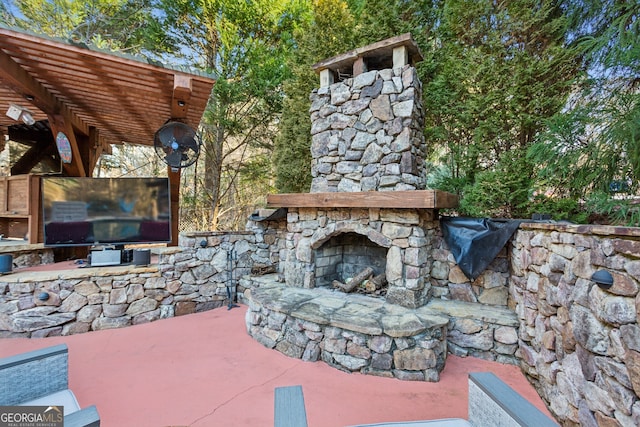 view of patio with an outdoor stone fireplace