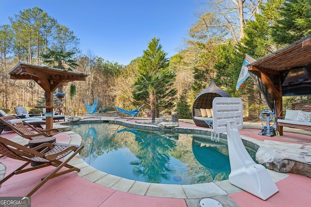 view of swimming pool featuring a patio area