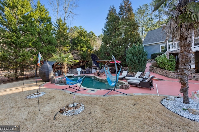 view of swimming pool with a patio