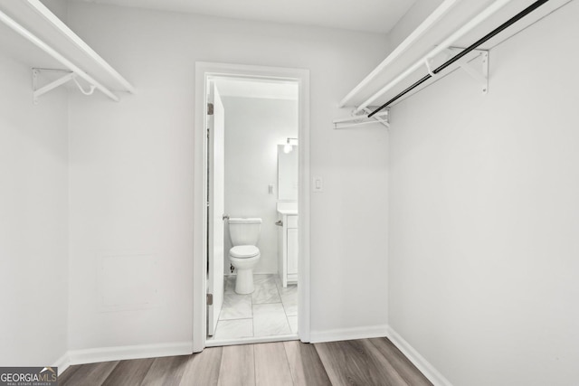 walk in closet featuring light wood-style floors