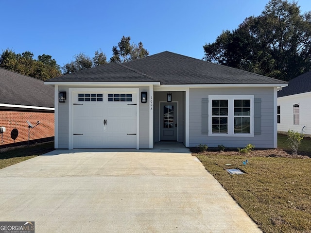 view of front of house with a garage and a front lawn