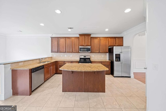 kitchen featuring a center island, stainless steel appliances, crown molding, and sink