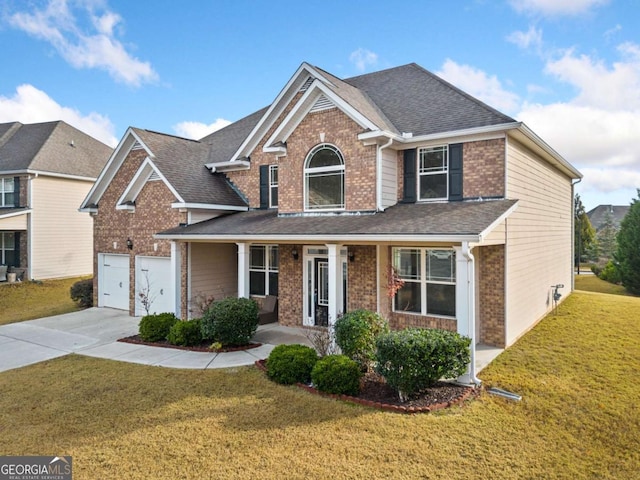 view of front property with a front lawn, a porch, and a garage