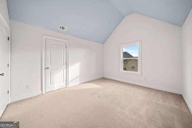 bonus room featuring light colored carpet and lofted ceiling