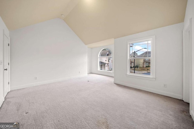 interior space featuring carpet floors and high vaulted ceiling