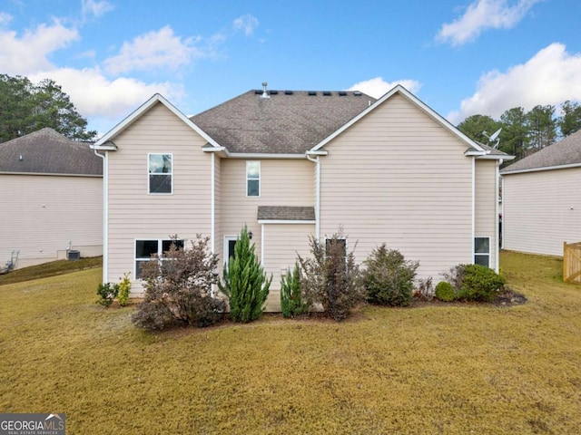 rear view of house with a lawn