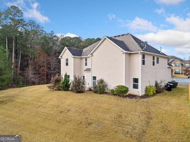 view of side of home featuring a yard