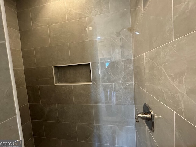 bathroom with a tile shower