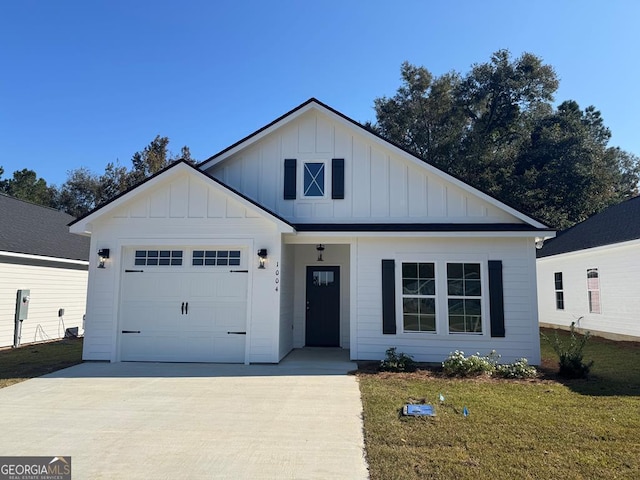 view of front of property with a front yard and a garage