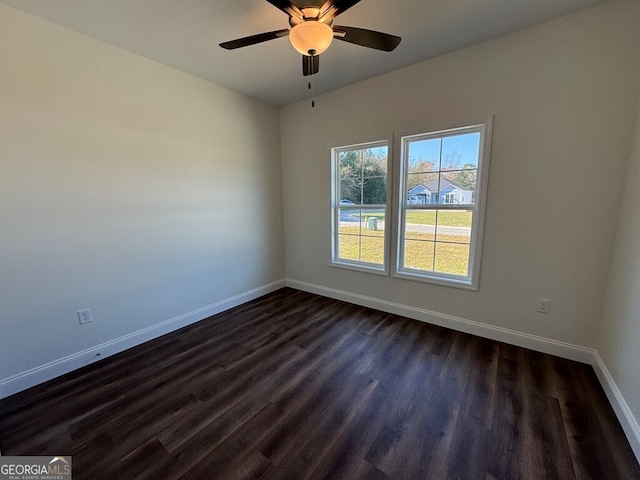 unfurnished room with dark hardwood / wood-style floors and ceiling fan