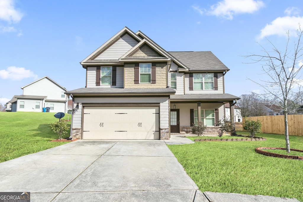 craftsman-style home with a garage and a front yard