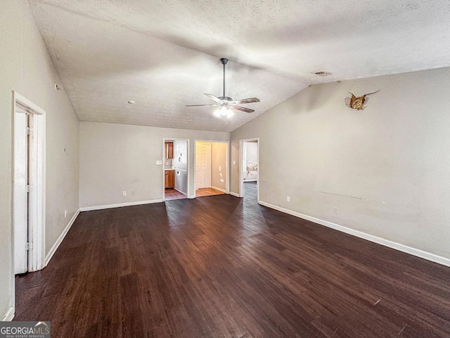 unfurnished living room featuring a textured ceiling, lofted ceiling, ceiling fan, and dark hardwood / wood-style floors